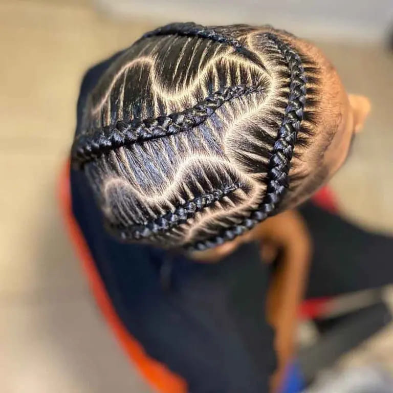 12 Twistiest Swirl Cornrows to Wow the Crowd 11 Swirl Cornrows With Snake-Shaped Hair Partition