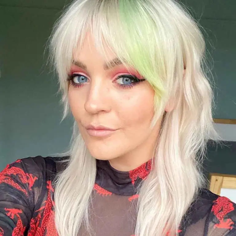 10 Edgy and Stylish Soft Mullet Hairstyles 9 Bleached Blonde Soft Mullet With Curtain Bangs and Mint Green Highlights