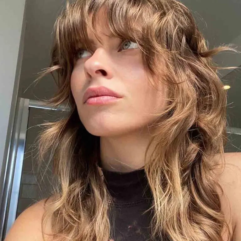 10 Sassy Wavy Wolf Cuts With Bangs 10 Brown Wavy Medium Mullet Wolf Cut With Tousled Bangs