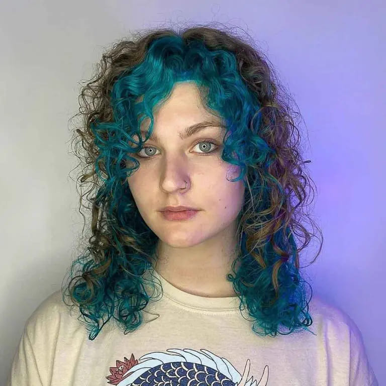 10 Wolf Cuts With Colored Bangs for Added Style 10 Curly Black Medium Wolf Cut With Cyan Curly Curtain Bangs