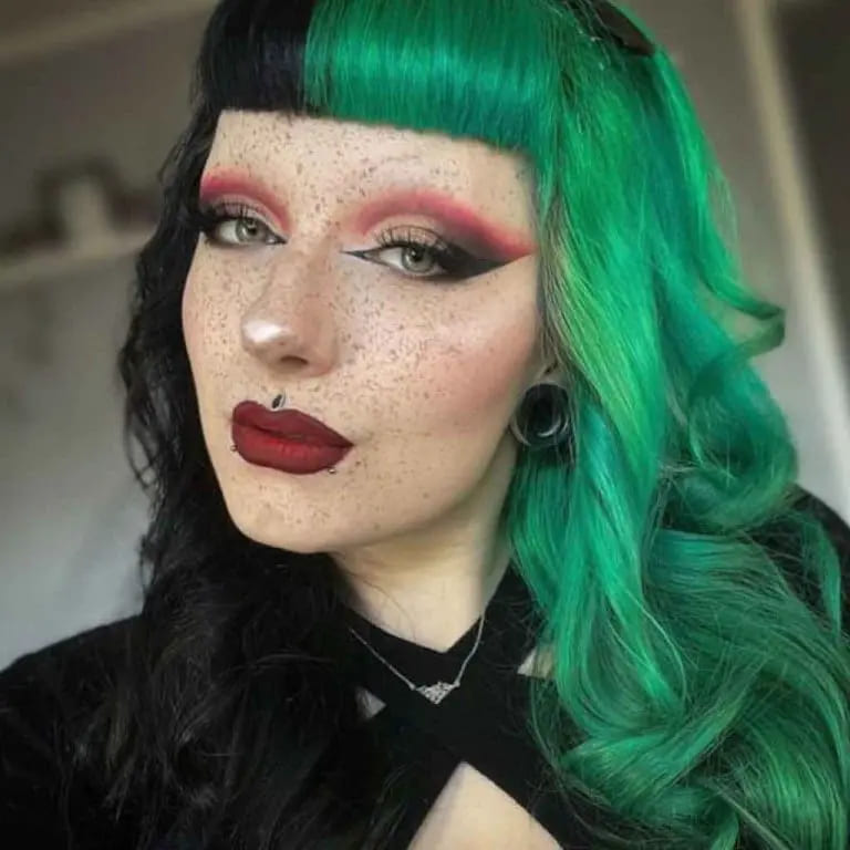 12 Gemini Hair Color Ideas to Embrace Dual-Toned Brilliance 11 Emo-Style Black and Emerald Wavy Gemini Hair With Blunt Micro Bangs