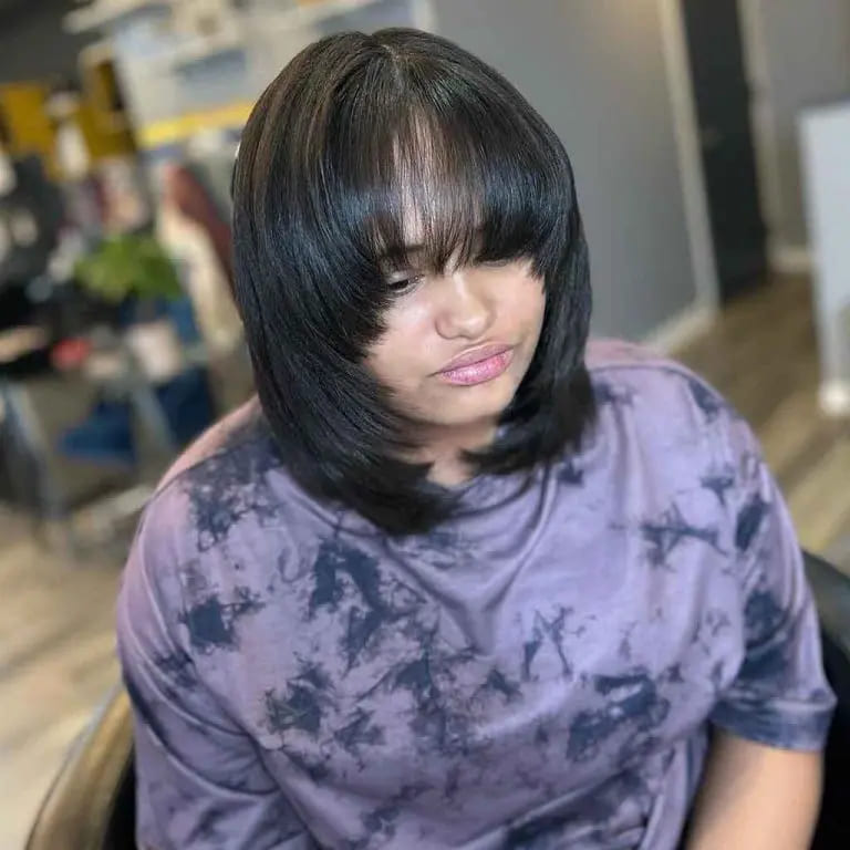 10 Black Wolf Cut Ideas for Women Ultimate Elegance 5 Face-Framing Bob Wolf Cut With Long Choppy Bangs on Shiny Black Hair