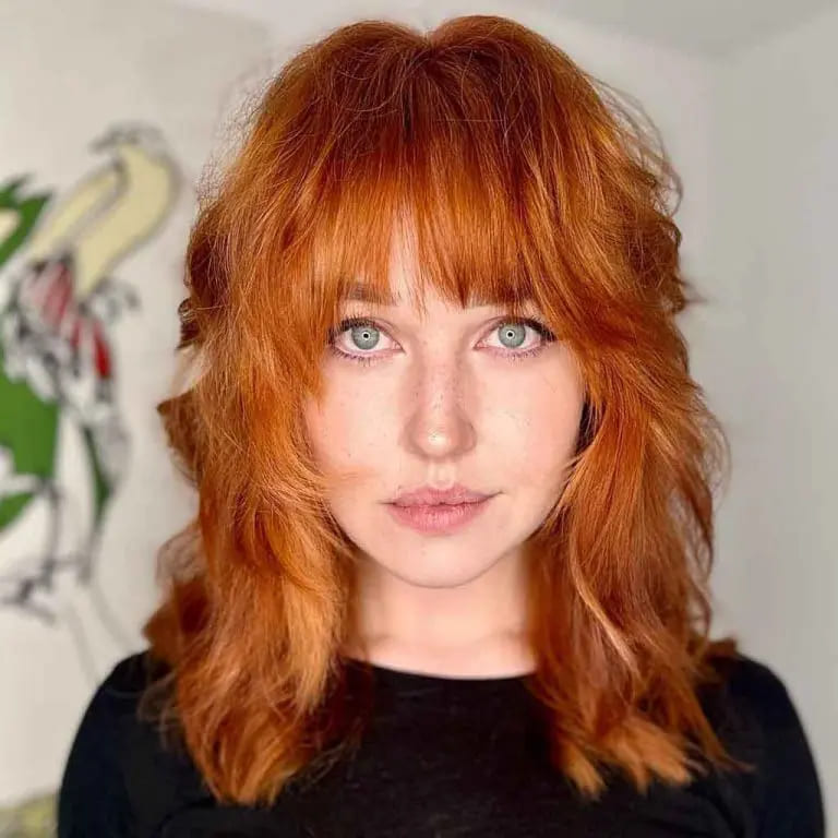 10 Spicy Ginger Wolf Cut Ideas for women 5 Ginger Wavy Wolf Cut With Face Layers and Bangs on Medium Hair