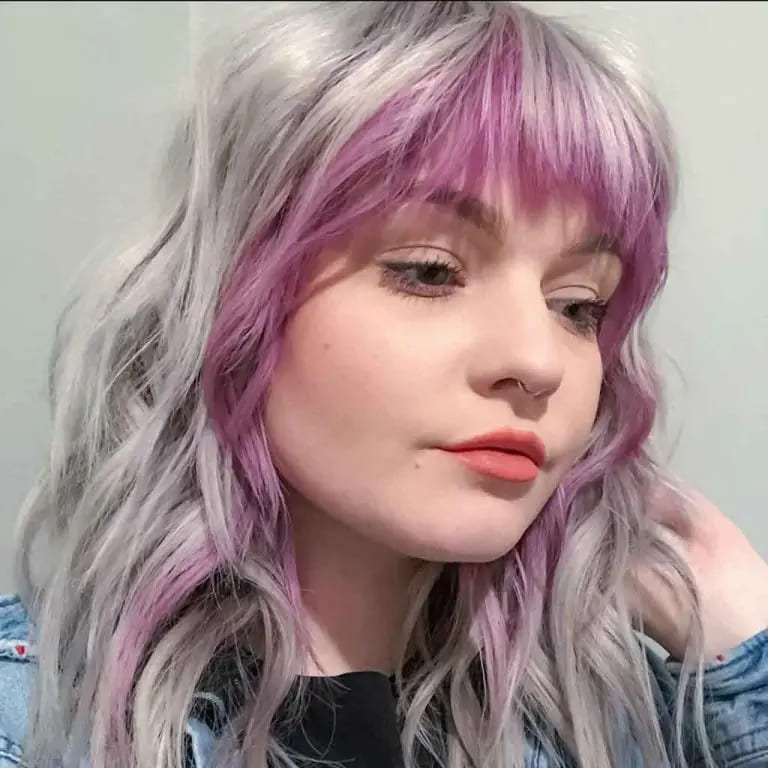 10 Wolf Cuts With Colored Bangs for Added Style 7 Long Ash Wavy Wolf Cut With Purple Highlights and Bangs