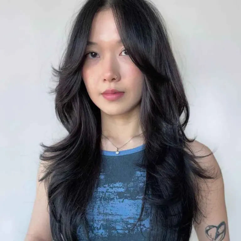 10 Black Wolf Cut Ideas for Women Ultimate Elegance 8 Long Black Wavy Layered Wolf Cut With Long Curtain Bangs