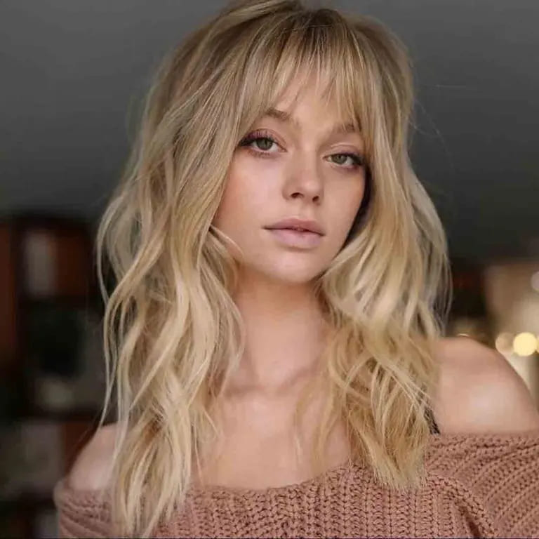 10 Sassy Wavy Wolf Cuts With Bangs 11 Long Blonde Octopus Wolf Cut With Choppy Bangs on Wavy Hair