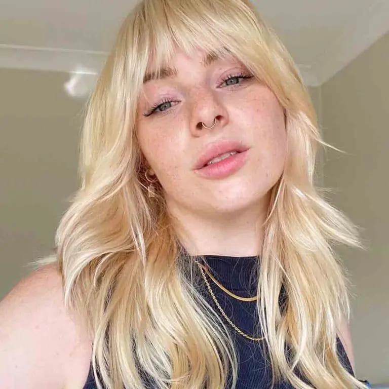 10 Sassy Wavy Wolf Cuts With Bangs 9 Long Blonde Wavy Wolf Cut With Asymmetric Bangs