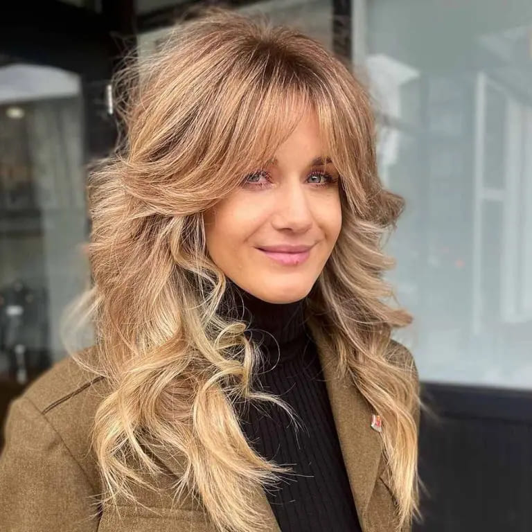 10 Sassy Wavy Wolf Cuts With Bangs 6 Long Blonde Wavy Wolf Cut With Curtain Bangs