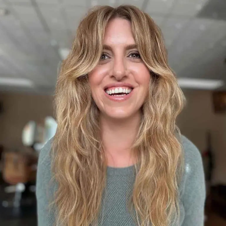 10 Long Wolf Cuts With Curtain Bangs to Wow the Crowd 2 Long Malibu Blonde Wavy Wolf Cut With Curtain Bangs