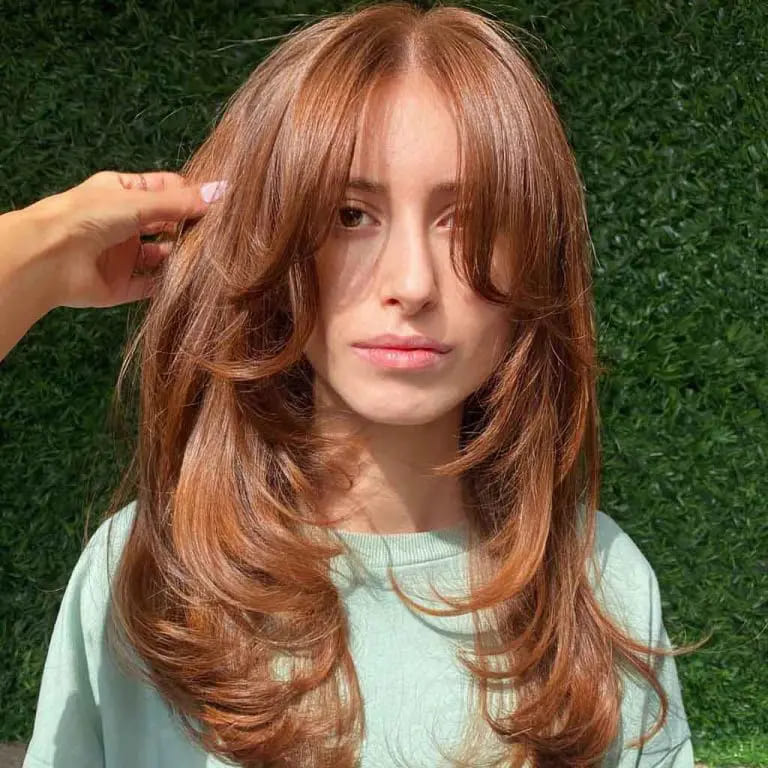 12 Butterfly Wolf Cut Ideas For Women 10 Long Sienna Brown Face Framing Butterfly Wolf Cut With Bottleneck Bangs