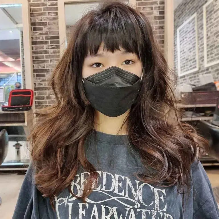 10 Brown Wolf Cut Ideas for Women to Elevate Your Style! 2 Long Wavy Messy Wolf Cut on Pecan Brown Hair With Choppy Bangs