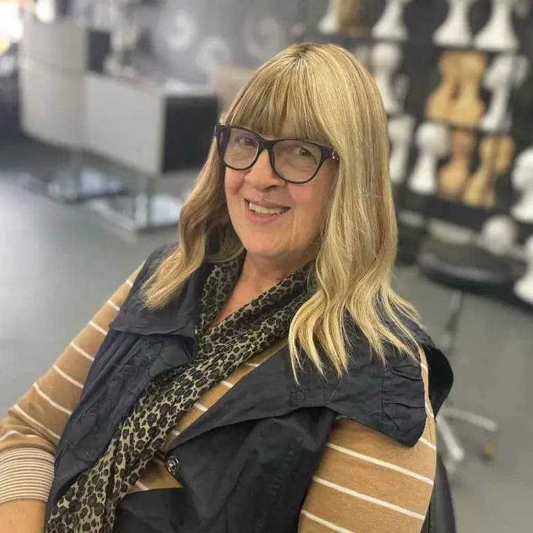 10 Stylish Haircuts for Women Over 50 4 Medium Blonde Wavy Hair With Blunt Bangs