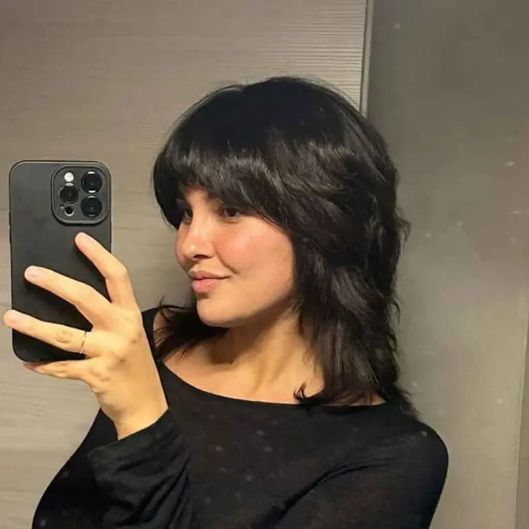 10 Black Wolf Cut Ideas for Women Ultimate Elegance 10 Medium Ebony Black Fluffy Mullet Wolf Cut With Asymmetric Bangs