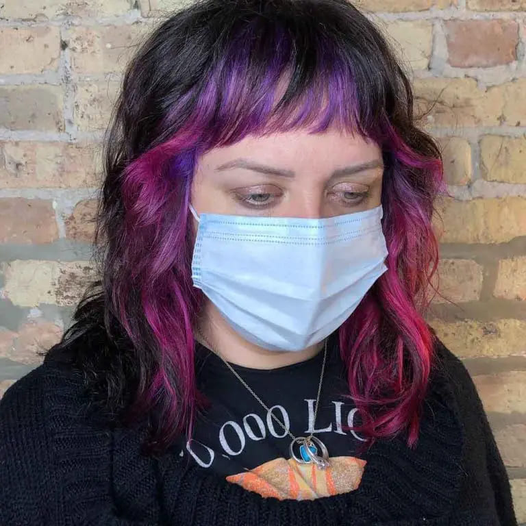 10 Wolf Cuts With Colored Bangs for Added Style 3 Medium Wolf Cut With Purple-Pink Highlights and Choppy Bangs