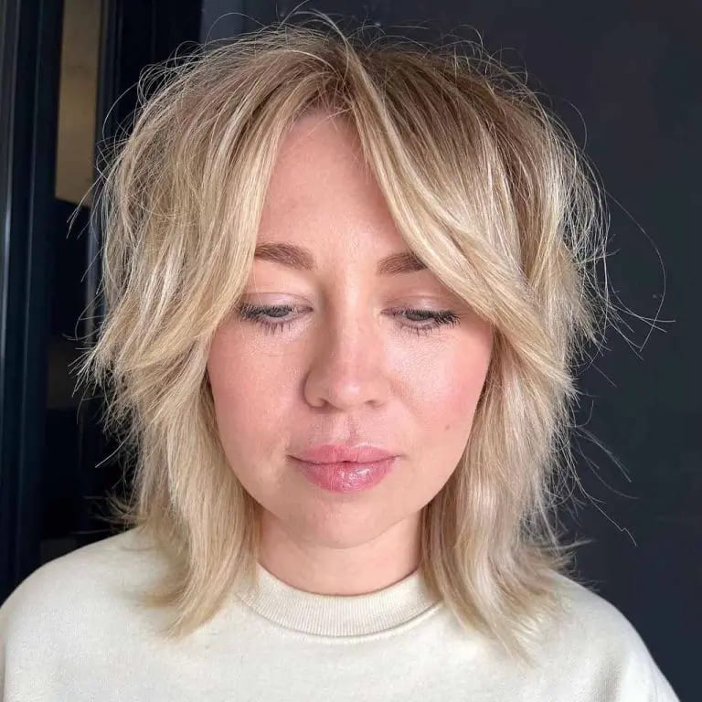 10 Best Wolf Cuts With Curtain Bangs 7 Messy Short Blonde Wolf Cut With Curtain Bangs