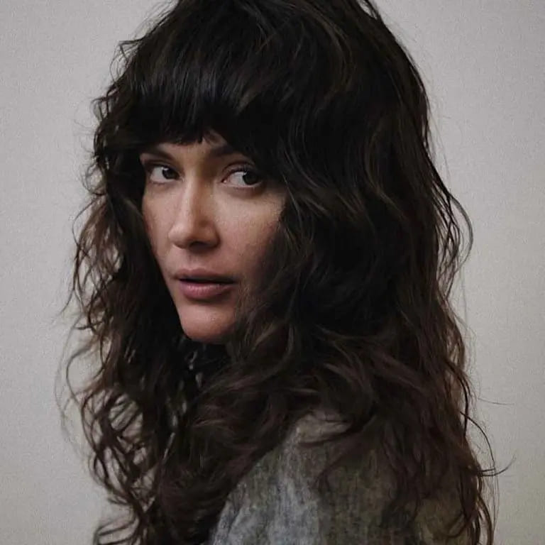 10 Black Wolf Cut Ideas for Women Ultimate Elegance 7 Midnight Black Wavy and Shaggy Long Wolf Cut With Blunt Bangs