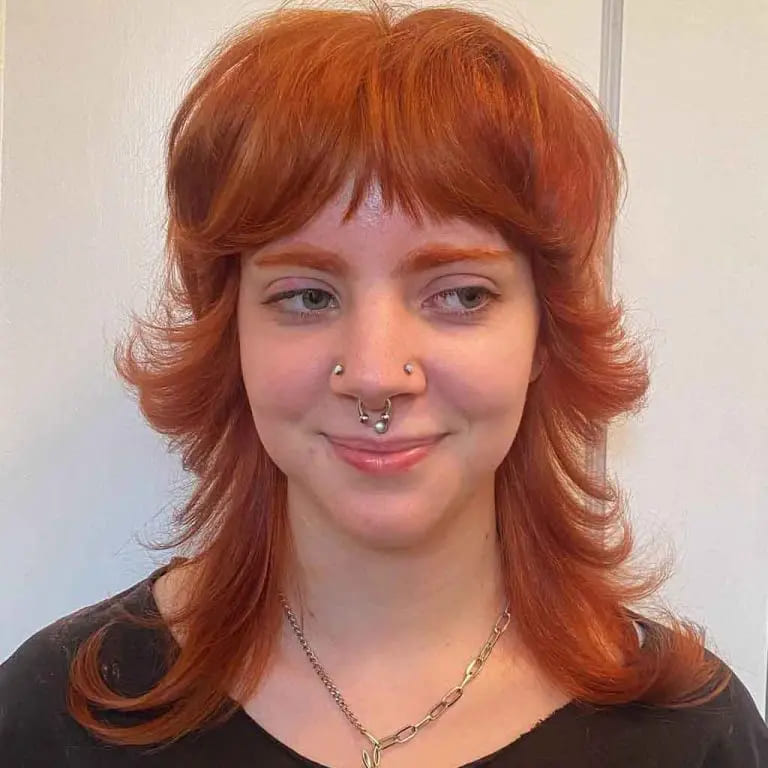 10 Spicy Ginger Wolf Cut Ideas for women 2 Mullet Layered Golden Toasted Auburn Ginger Wolf Cut With Short Curtain Bangs