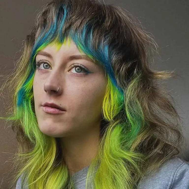10 Classy Shaggy Wolf Cuts With Bangs 9 Shaggy Wolf Cut With Tousled Colorful Bangs and Front Layers