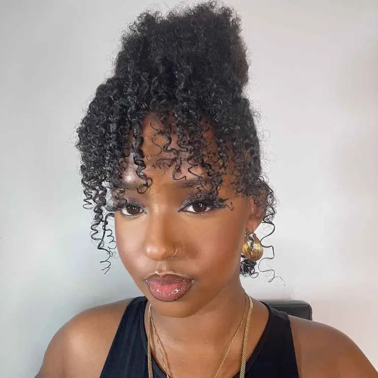 10 Stunning Hairstyles for Black Women 7 Short Curly Hair With a Messy Top Bun
