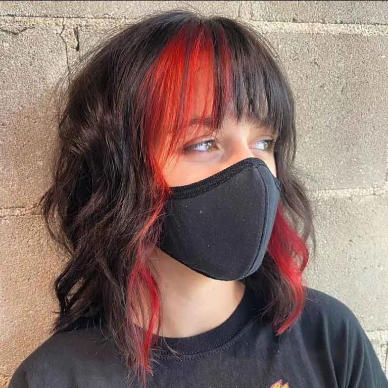 10 Wolf Cuts With Colored Bangs for Added Style 11 Short Wavy Black Wolf Cut With Red and Black Choppy Bangs