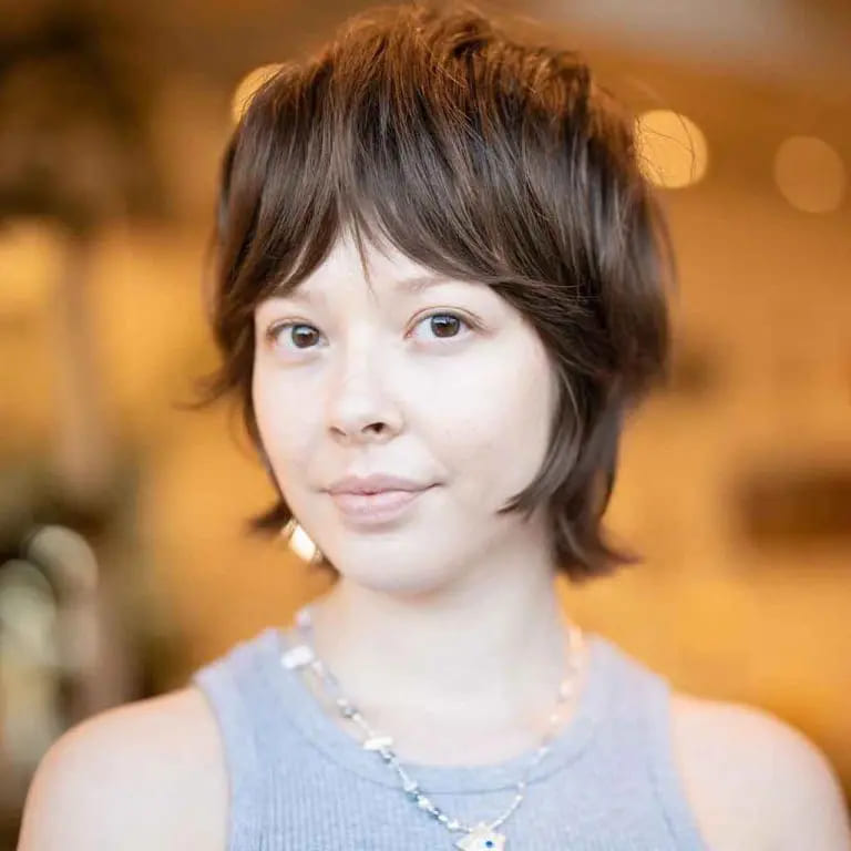 10 Short Wolf Cuts With Curtain Bangs 5 Soft Pixie Wolf Cut on Caramel and Dark Brown Hair With Dense Curtain Bangs