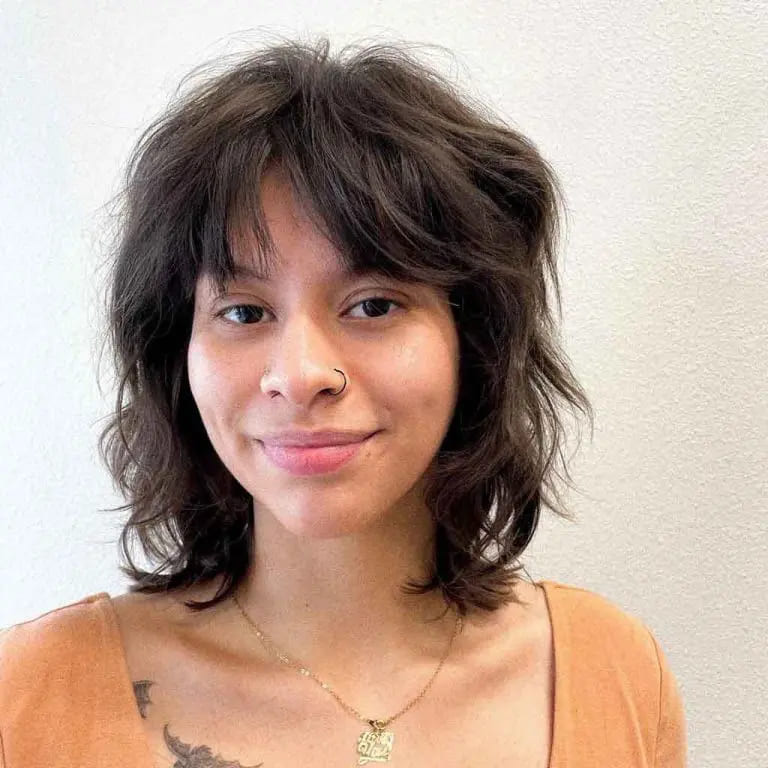 10 Short Wolf Cuts With Curtain Bangs 9 Tousled Black Short Wolf Cut With Choppy and Messy Curtain Bangs