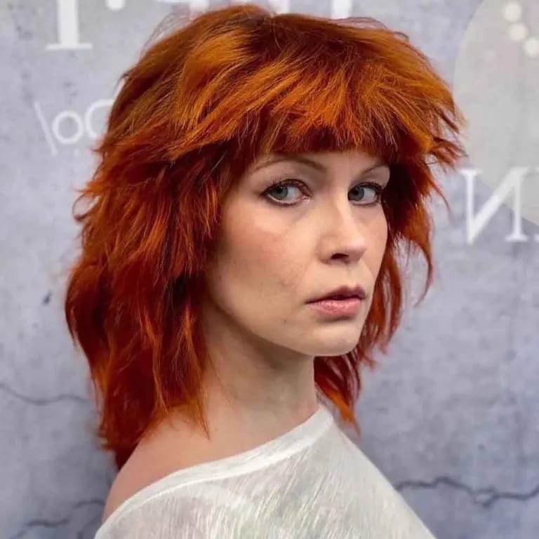 10 Spicy Ginger Wolf Cut Ideas for women 10 Tousled Goldish Ginger Short Mullet Wolf Cut With Bangs