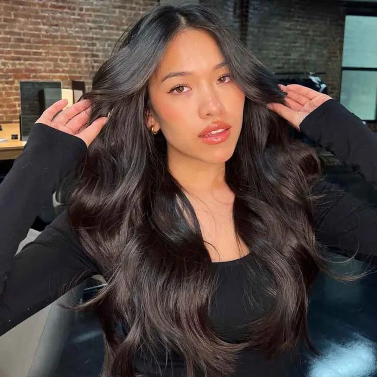 10 Hairstyles for Oval-Shaped Face 2 Long Wavy Black Hair With Face Framing Invisible Layers
