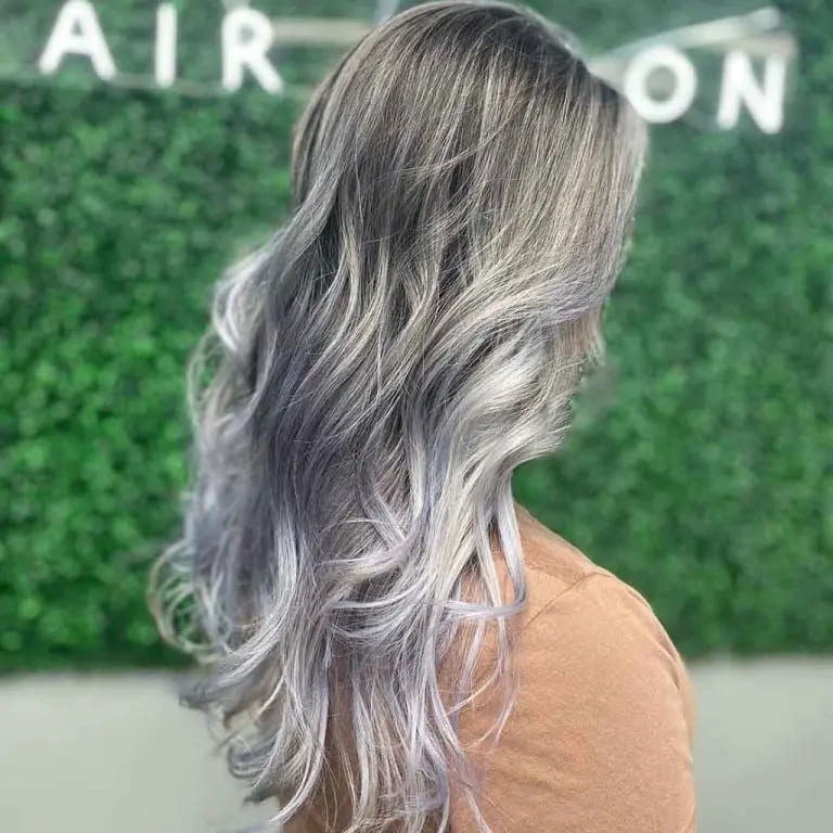 12 Shining Hairstyles With Silver Highlights 9 Long Tousled Wavy Hair With Silver Balayage Ombre and Babylights