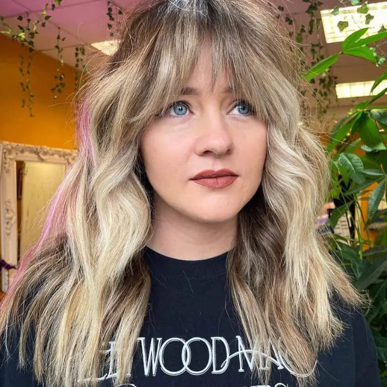 10 Beautiful Blonde Wolf Cut With Bangs 3 Wavy Blonde Medium Wolf Cut With Brown-Pink Highlights and Curtain Bangs