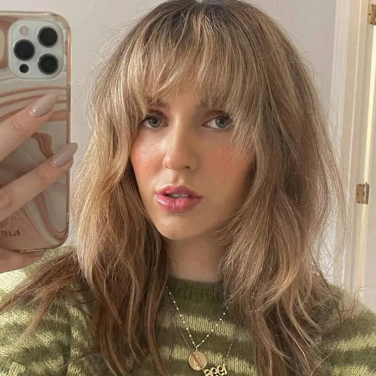 10 Beautiful Variations of Wolf Cut With Bangs For Women 11 Wavy Blonde Wolf Cut With Choppy Bangs