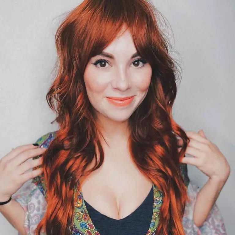 10 Long Wolf Cuts With Curtain Bangs to Wow the Crowd 9 Wavy Dark Ginger Wolf Cut With Curtain Bangs