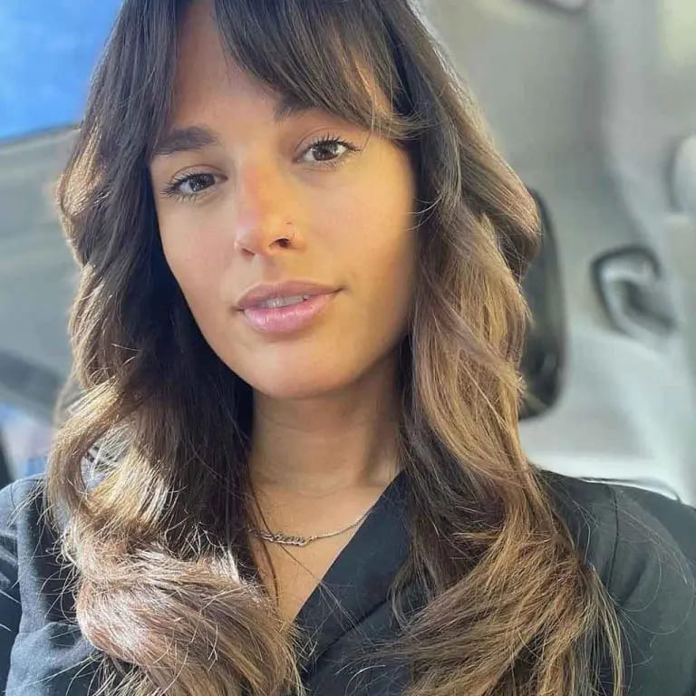 10 Long Wolf Cuts With Curtain Bangs to Wow the Crowd 5 Wavy Golden Brown Wolf Cut With Curtain Bangs