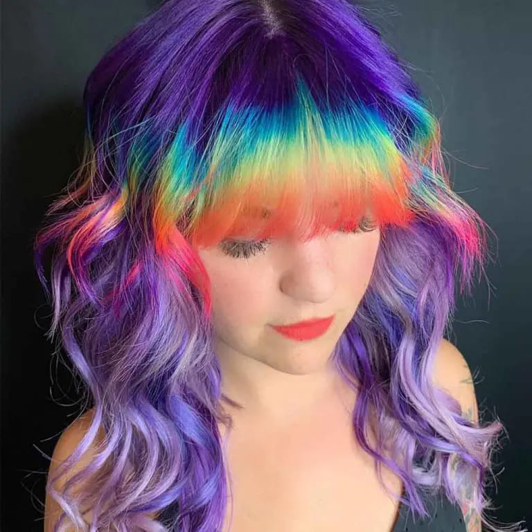 10 Wolf Cuts With Colored Bangs for Added Style 2 Wavy Purple Wolf Cut With Rainbow Colored Clip-On Bangs