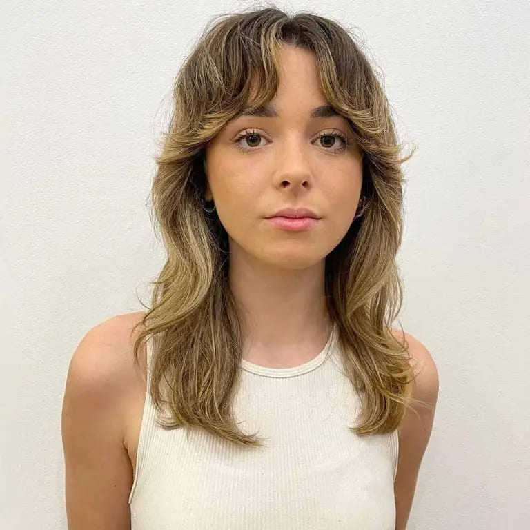 10 Top Balayage Wolf Cut Ideas For Women 8 Wavy Soft Shag Wolf Cut With Balayage and Wavy Curtain Bangs