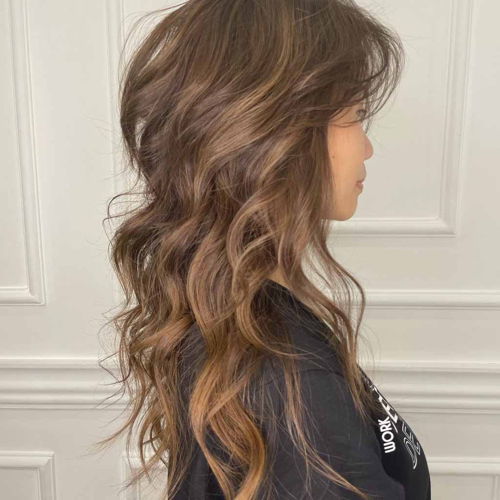 20 Best Fluffy Wolf Cut Ideas for Your Signature Style! 7 Long Wavy Wolf Cut With Fall Bronde Balayage
