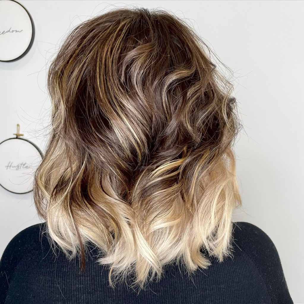 20 Best Fluffy Wolf Cut Ideas for Your Signature Style! 2 Brown Fluffy Wolf Cut With Blonde Highlights