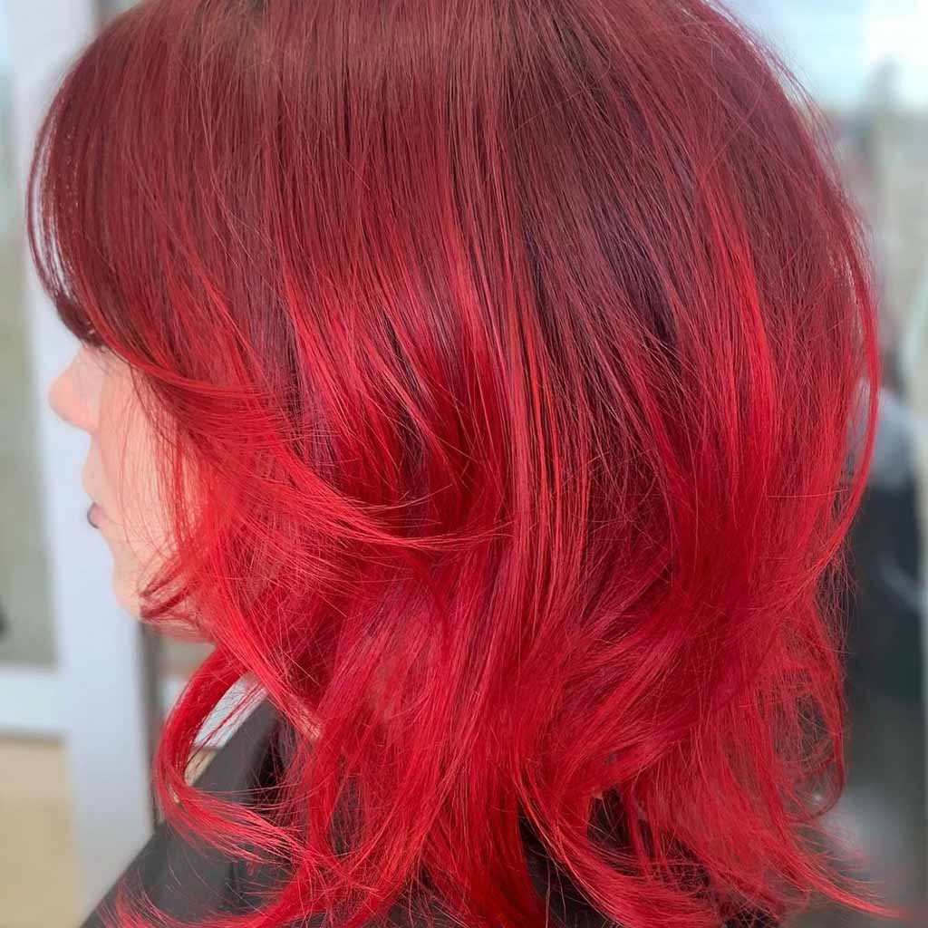 20 Best Fluffy Wolf Cut Ideas for Your Signature Style! 10 Short Fluffy Wolf Cut With Bright Red Highlights