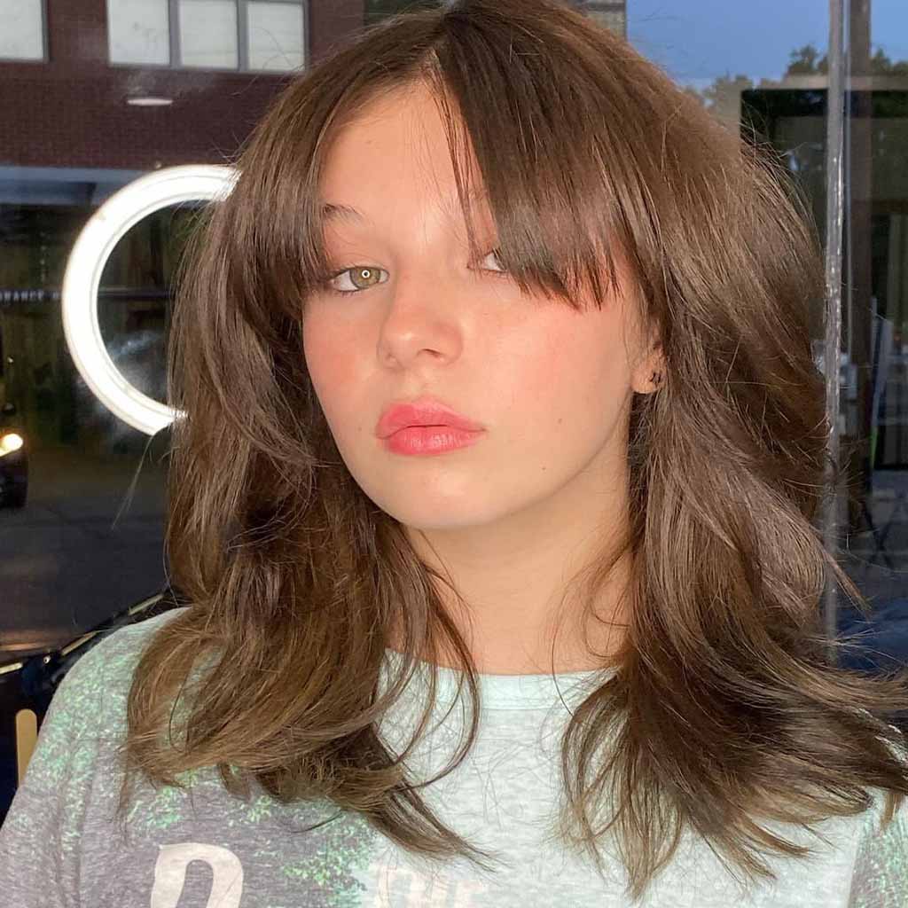 20 Best Fluffy Wolf Cut Ideas for Your Signature Style! 12 Brown Mullet Wolf Cut With Parted Bangs