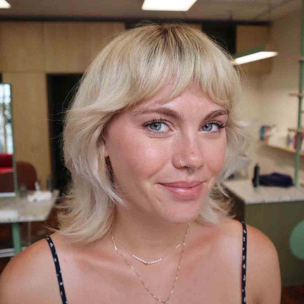 20 Classy Short Wolf Cut Ideas to Turn Heads! 9 Blonde Short Wolf Cut With Curtain Bangs