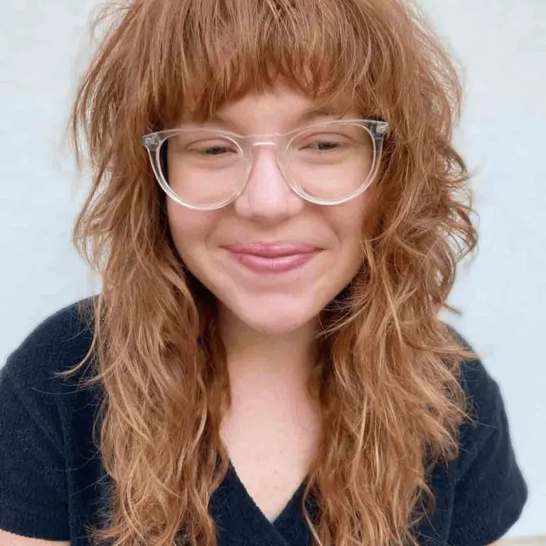 10 Classy Shaggy Wolf Cuts With Bangs 1 1. Curly Shaggy Light Brown Wolf Cut With Messy Bangs 1