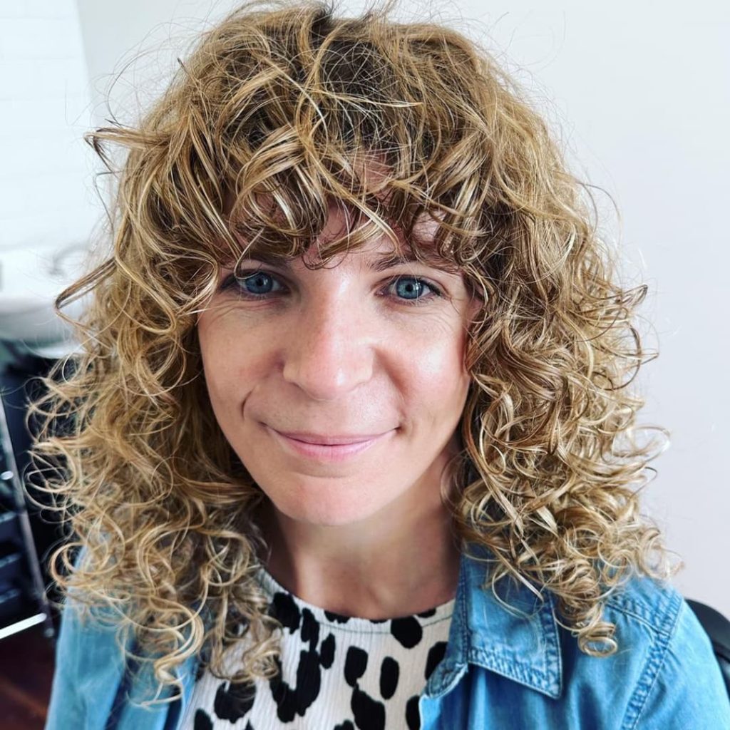 30 Best Curly Wolf Cut Ideas to Showcase Your Beautiful Curls 24 Short Blonde Curly Hair with a Shaggy Wolf Cut