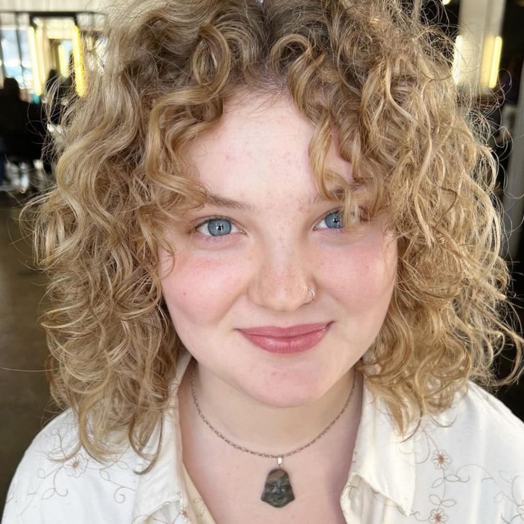30 Best Curly Wolf Cut Ideas to Showcase Your Beautiful Curls 28 Short Curly Wolf Cut with Blonde Balayage