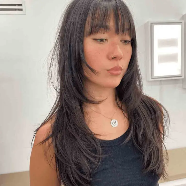 10 Classy Shaggy Wolf Cuts With Bangs 3 3. Layered Shag Wolf Cut With Choppy Bangs on Long Hair