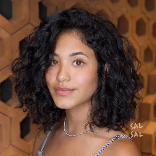 10 Latest Hairstyles for Naturally Curly Hair 3 3. Pretty Curly Black Bob with Side Bangs 1
