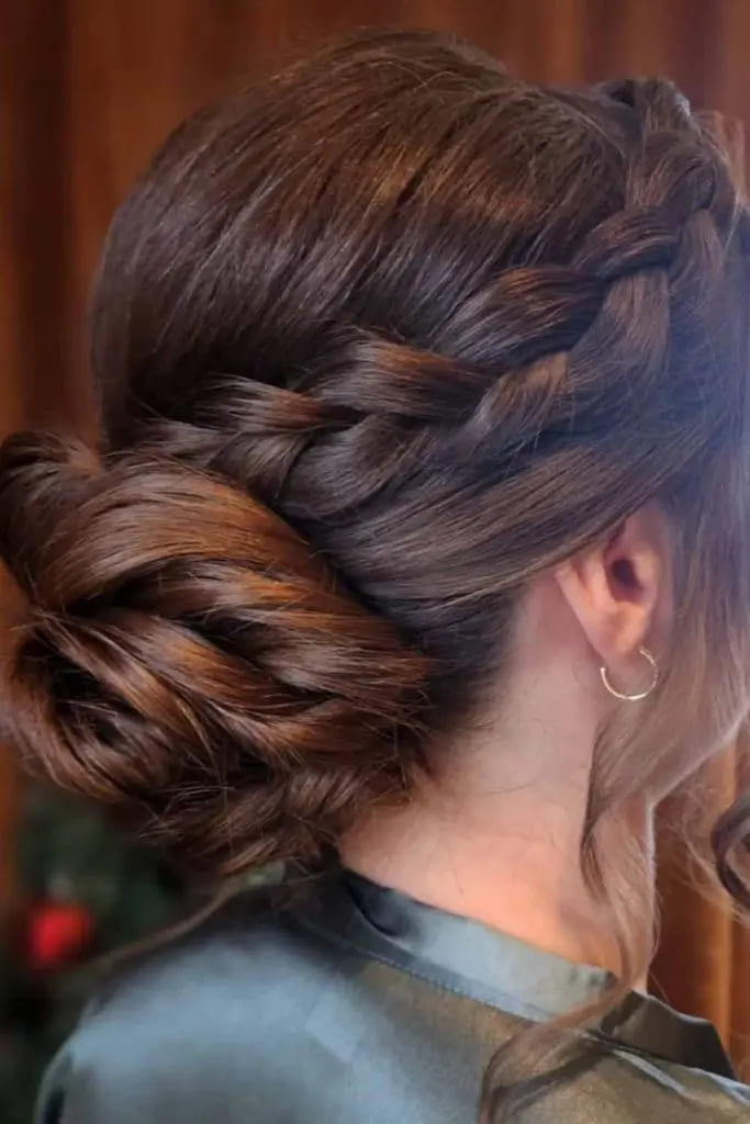 12 Stunning Hairstyles for Bridesmaids 5 5. Low Plaited Brunette Bun With Wavy Tendrils 1
