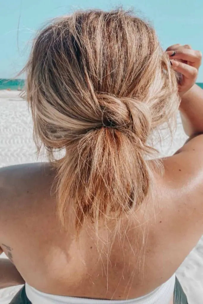 12 Sun-Kissed Beach Hairstyles 5 5. Low Tucked In Messy Bun