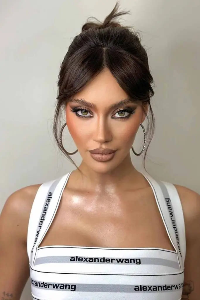 12 Hairstyles for Any and Every Hair Type 6 6. High Bun With Curtain Bangs