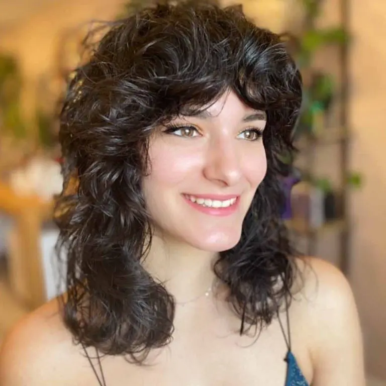 10 Classy Shaggy Wolf Cuts With Bangs 7 7. Medium Shag Wolf Cut With Wavy Curtain Bangs 1