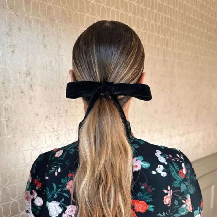 10 Slick Ponytail Hairstyle Ideas 9 9. Low with Bows Slick Ponytail